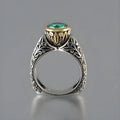 Gold and silver vintage flower-shaped ring with a central green gemstone, shown in a size selection.