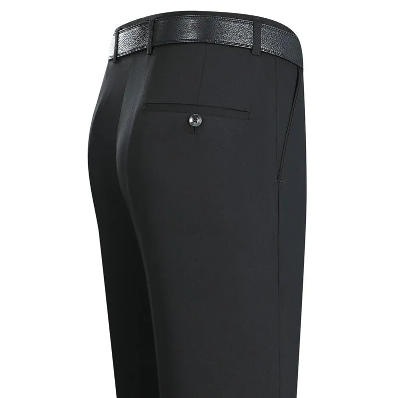 Man wearing black straight-leg high-waisted non-iron business trousers made from a Mulberry Silk blend fabric.