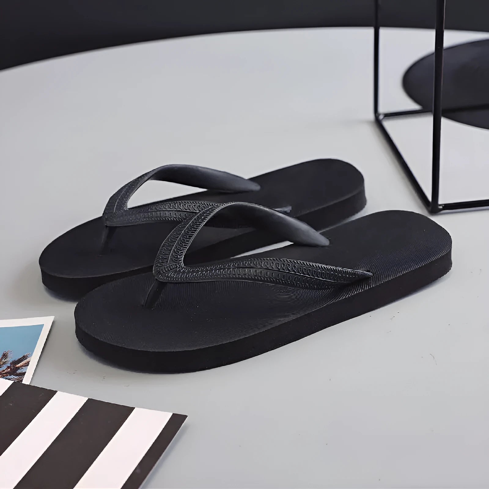 Rubber beach flip-flops with fish label design in green, red, blue, and black colour options