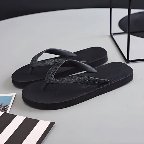Rubber beach flip-flops with fish label design in green, red, blue, and black colour options