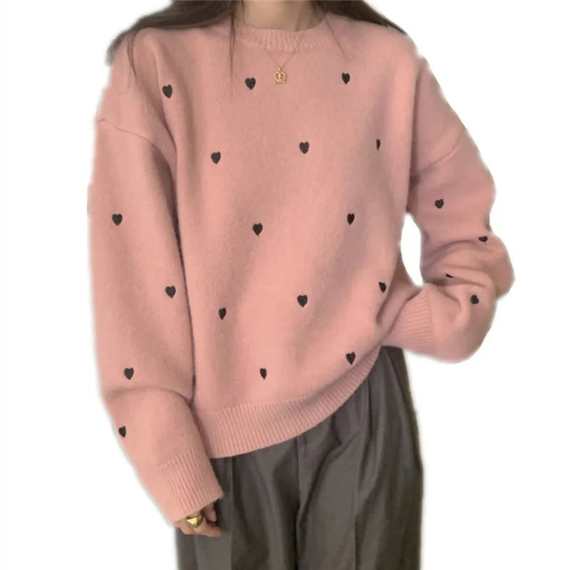 Women's loose grey acrylic pullover sweater with embroidery detail on the front, featuring long sleeves and a crew neck.