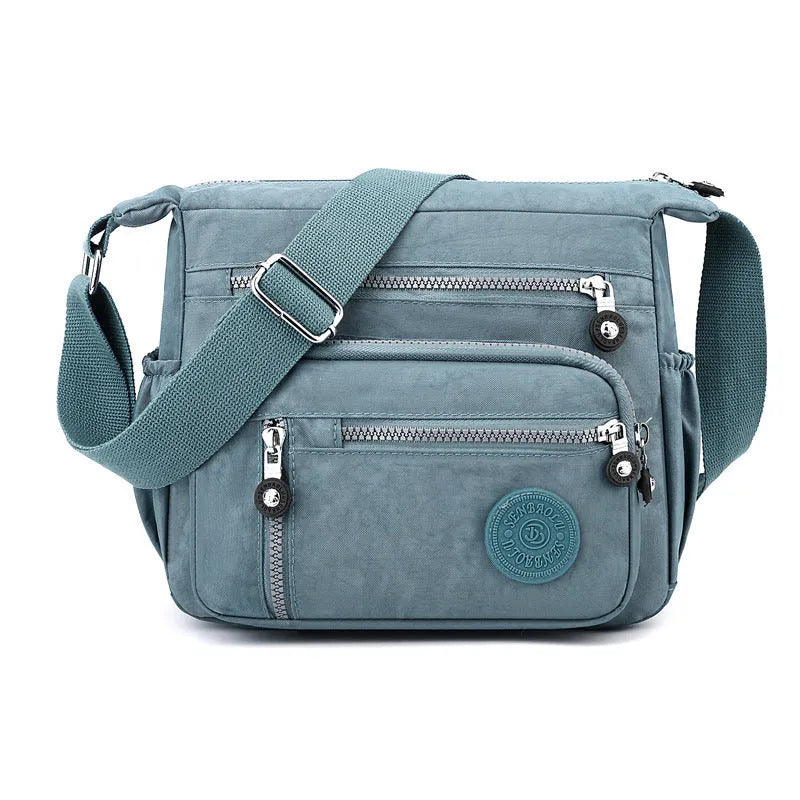 Nylon messenger bag in grey colour with single shoulder strap and square vertical design