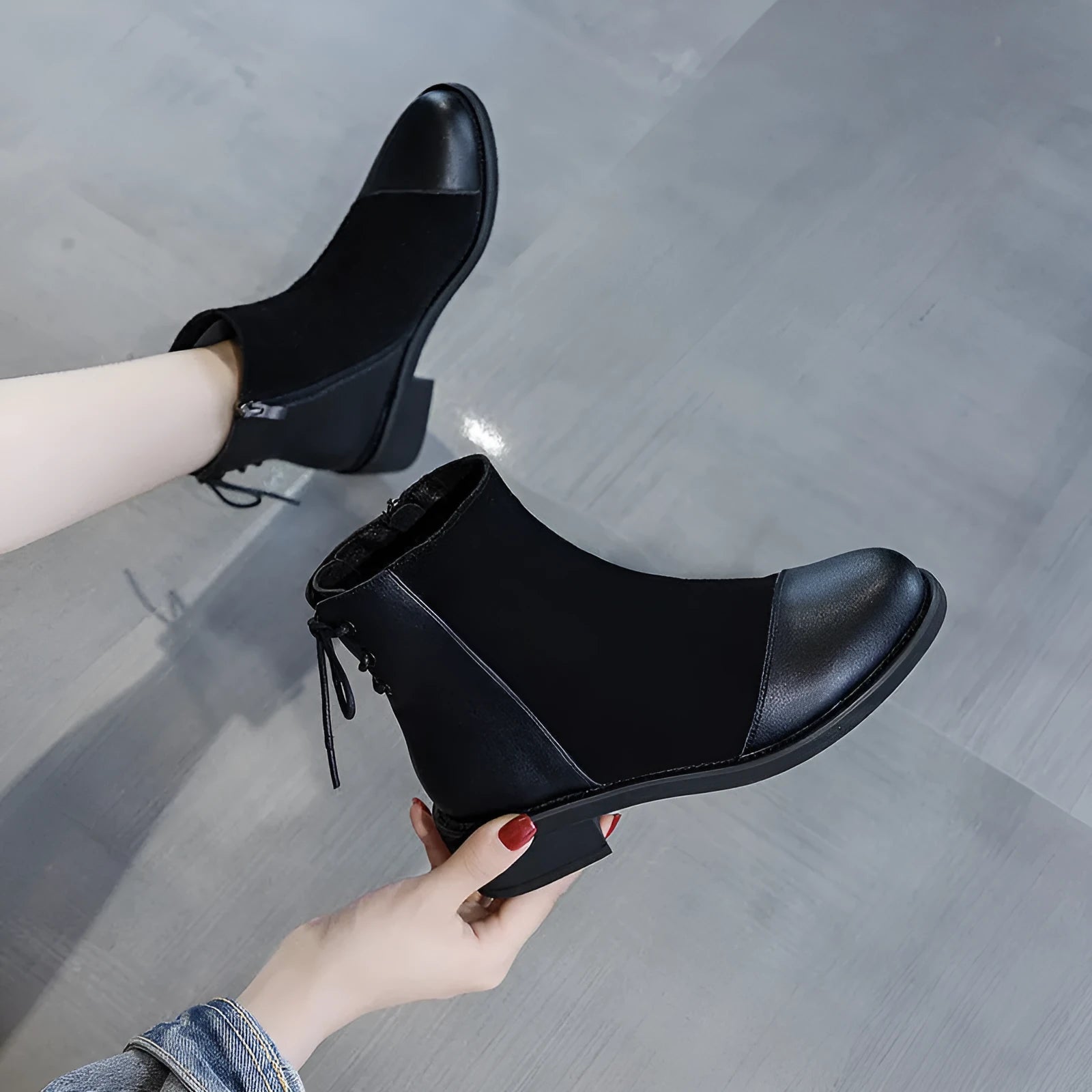 Black women's knee-high Martin boots with side zip and round toe on a short stout heel.
