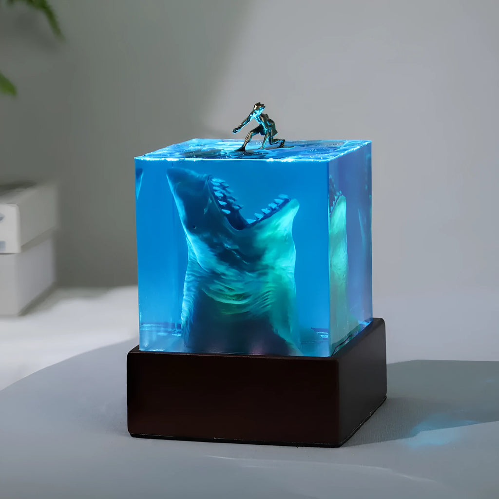 Epoxy resin shark surfer night light ornament on a desk, showing 5cm and 8cm size options.