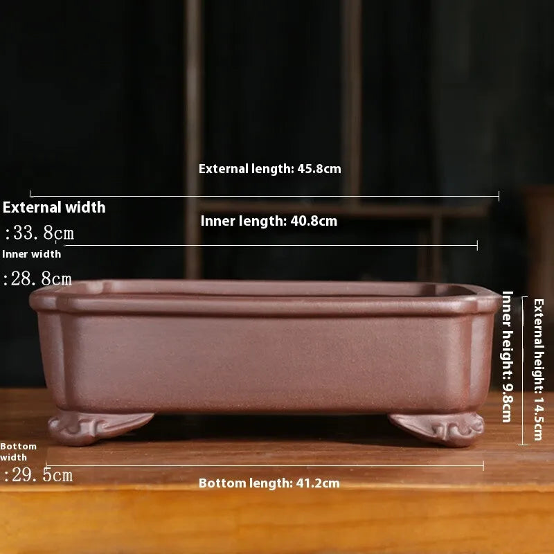 Antique-style rectangular purple sand planter with cut corners on a floor.