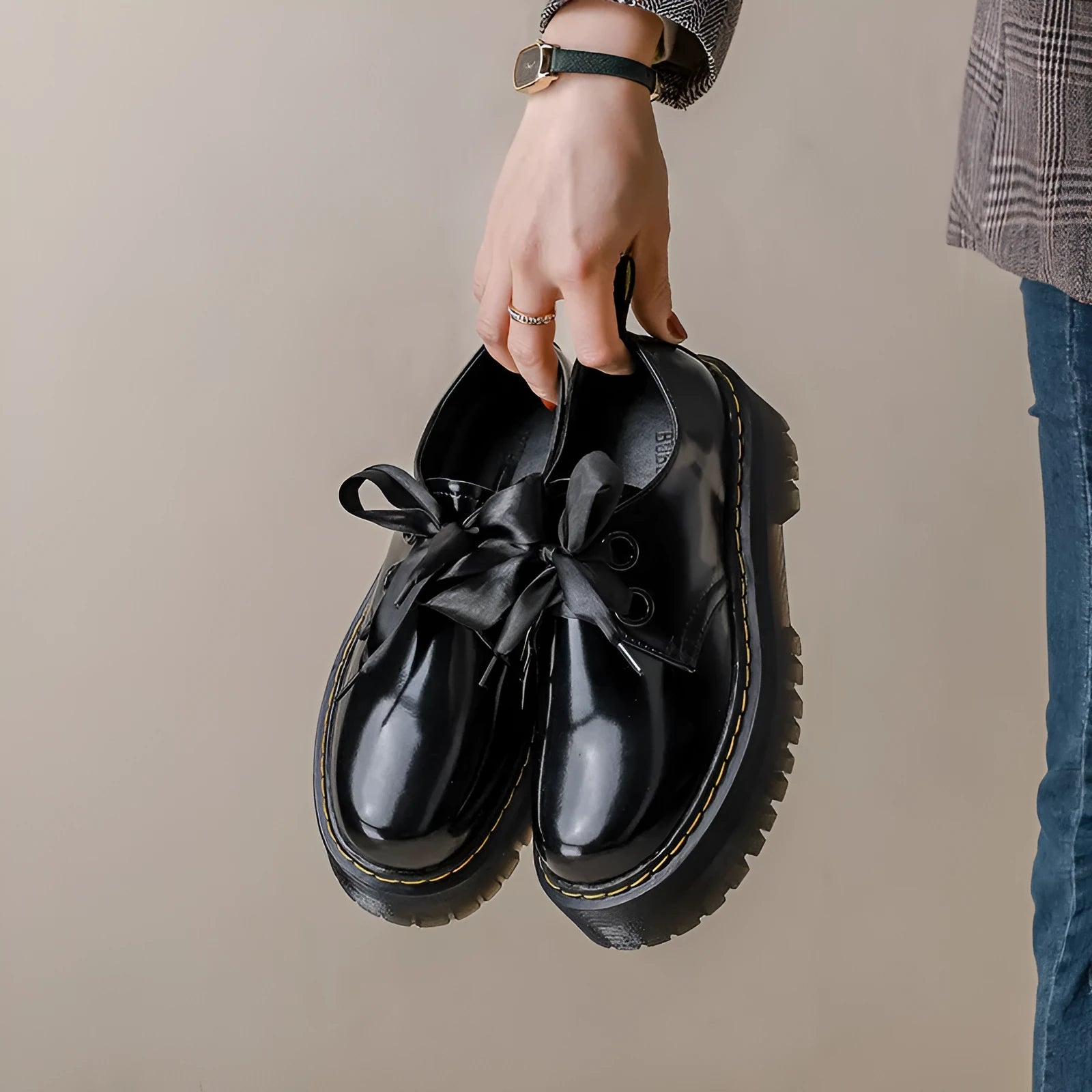 Women's thick soled leather shoes with cross strap design and lace closure in black colour