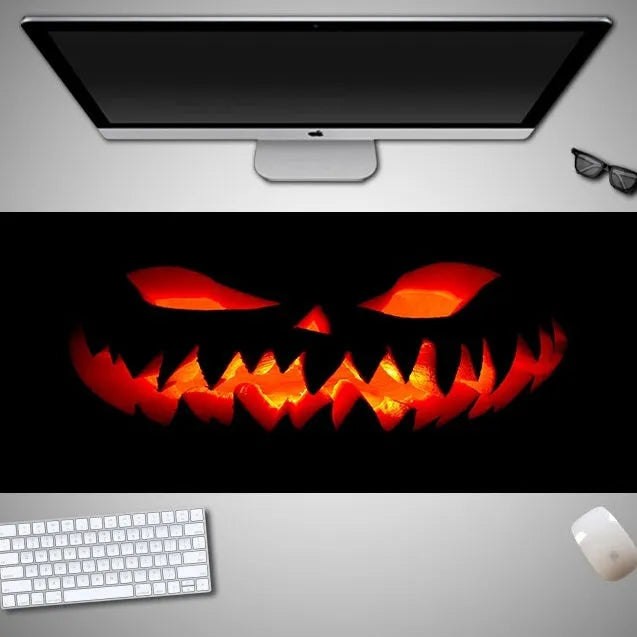 Oversized Halloween-themed computer mouse pad with non-slip rubber cloth base on a desk