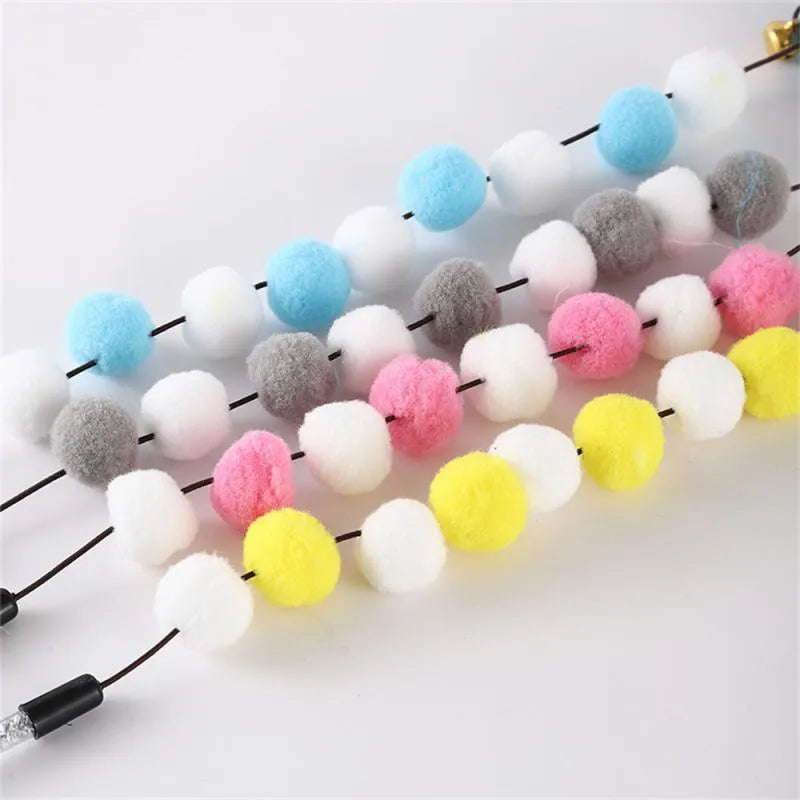 Colourful cat teaser stick with bell and feather toys measuring 31cm long