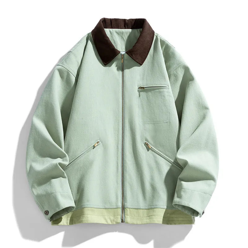 Man wearing a loose-fit mint green casual jacket with dark contrast lapels and side seam pockets.