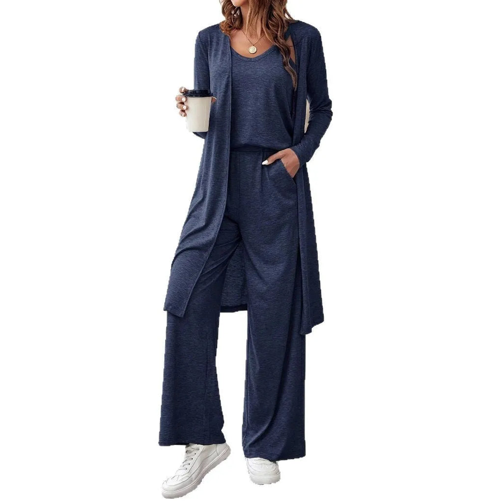 Blue women's three-piece suit featuring cardigan trousers, a long-sleeve top, and suspenders on a hanger.