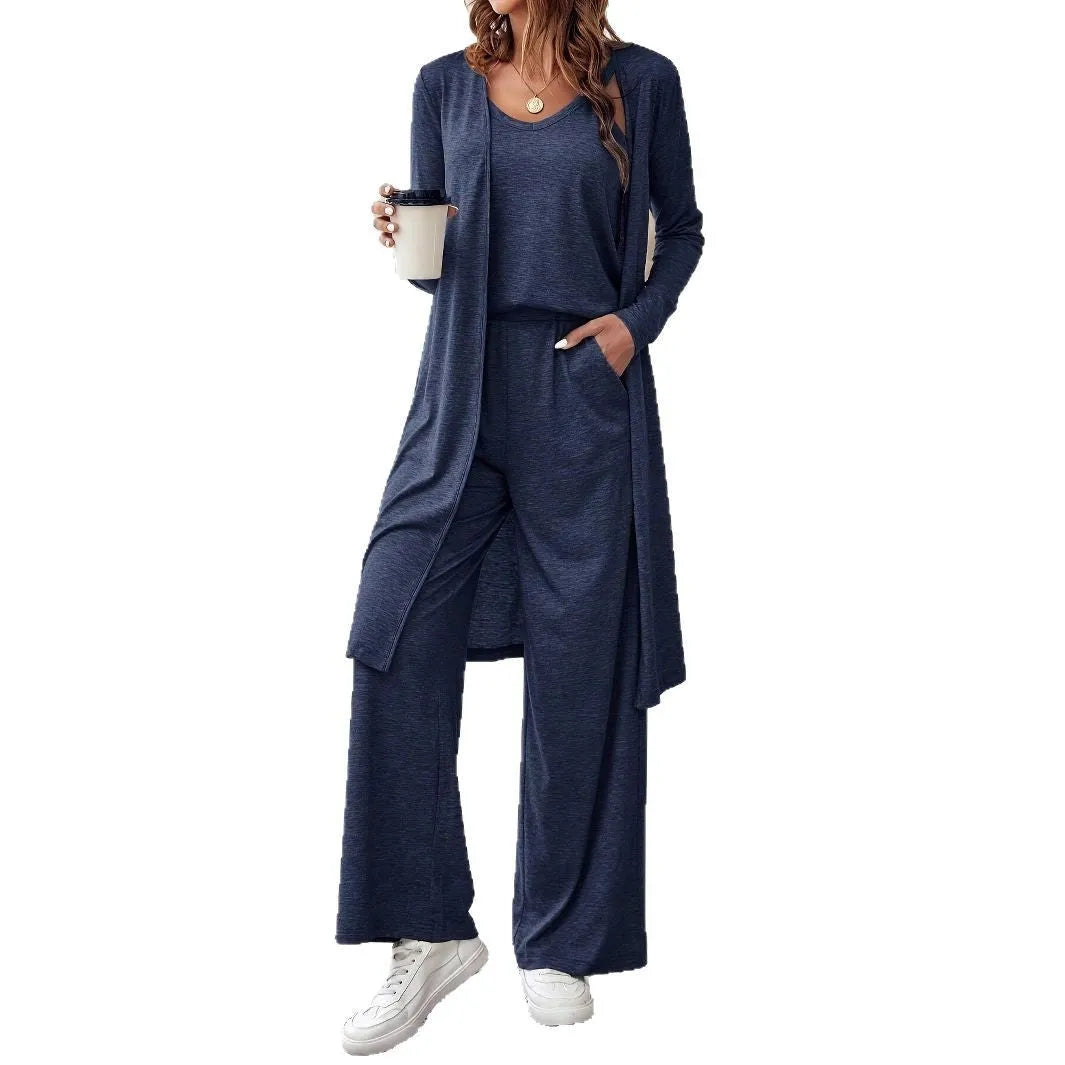 Blue women's three-piece suit featuring cardigan trousers, a long-sleeve top, and suspenders on a hanger.
