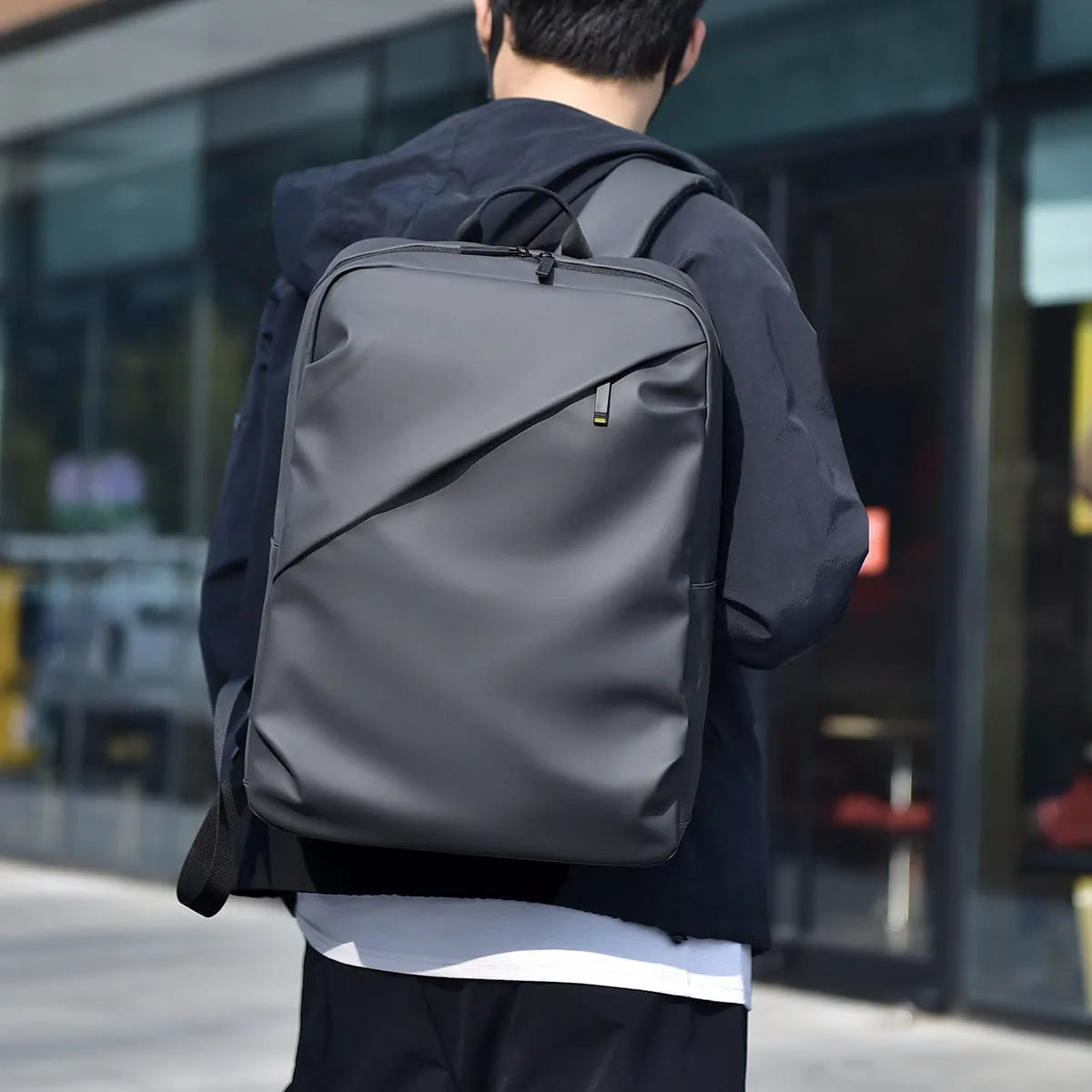 Waterproof black PU leather backpack with sewing thread details and large capacity storage