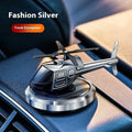 Silver metal helicopter car air freshener with rotating blades on dashboard