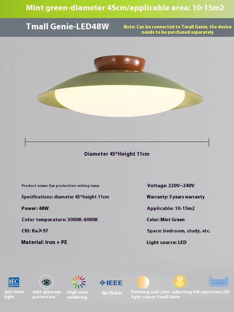 Modern minimalist flying saucer design ceiling lamp in cream yellow on a white ceiling.