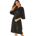 Black A-line midi dress with cinched belt and long sleeves on a mannequin