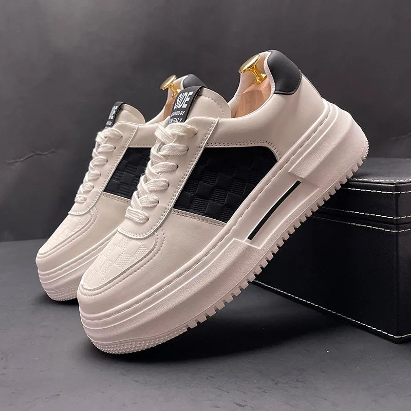 White and green sports casual shoes with cloth upper and rubber foam sole on a plain background.