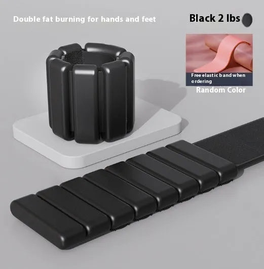 Adjustable black silicone fitness weight bracelet with Velcro strap shown on a wrist.