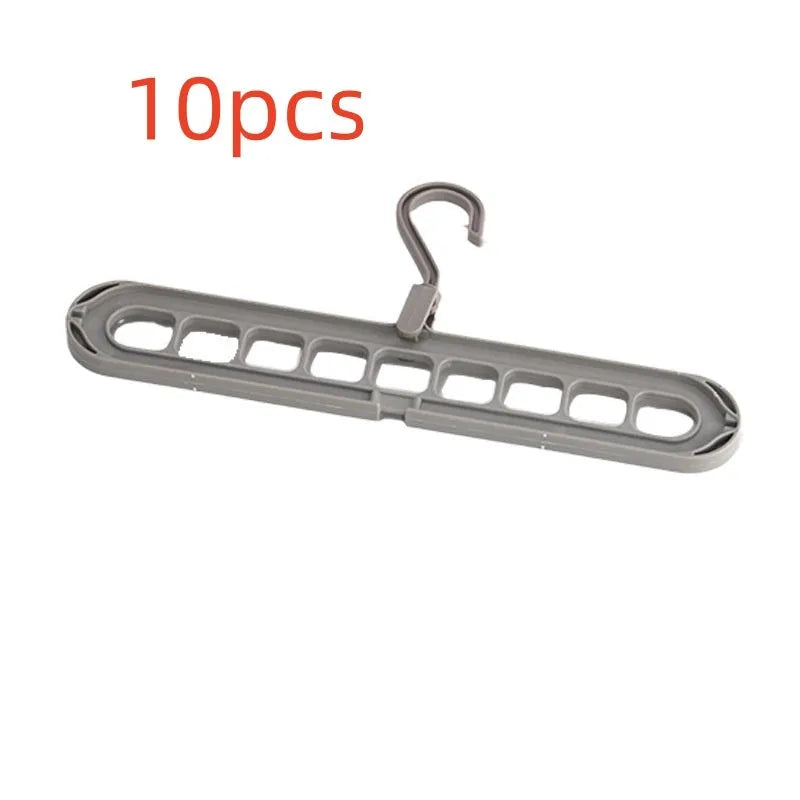 Green plastic nine-hole folding hanger for trousers displayed open and closed.