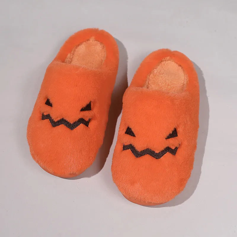 Orange women's pumpkin-themed plush slippers with a coral velvet upper and a flat non-slip sole.