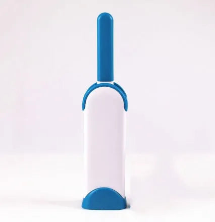 Blue reusable pet hair removal brush with self-cleaning base for sofas and upholstery.