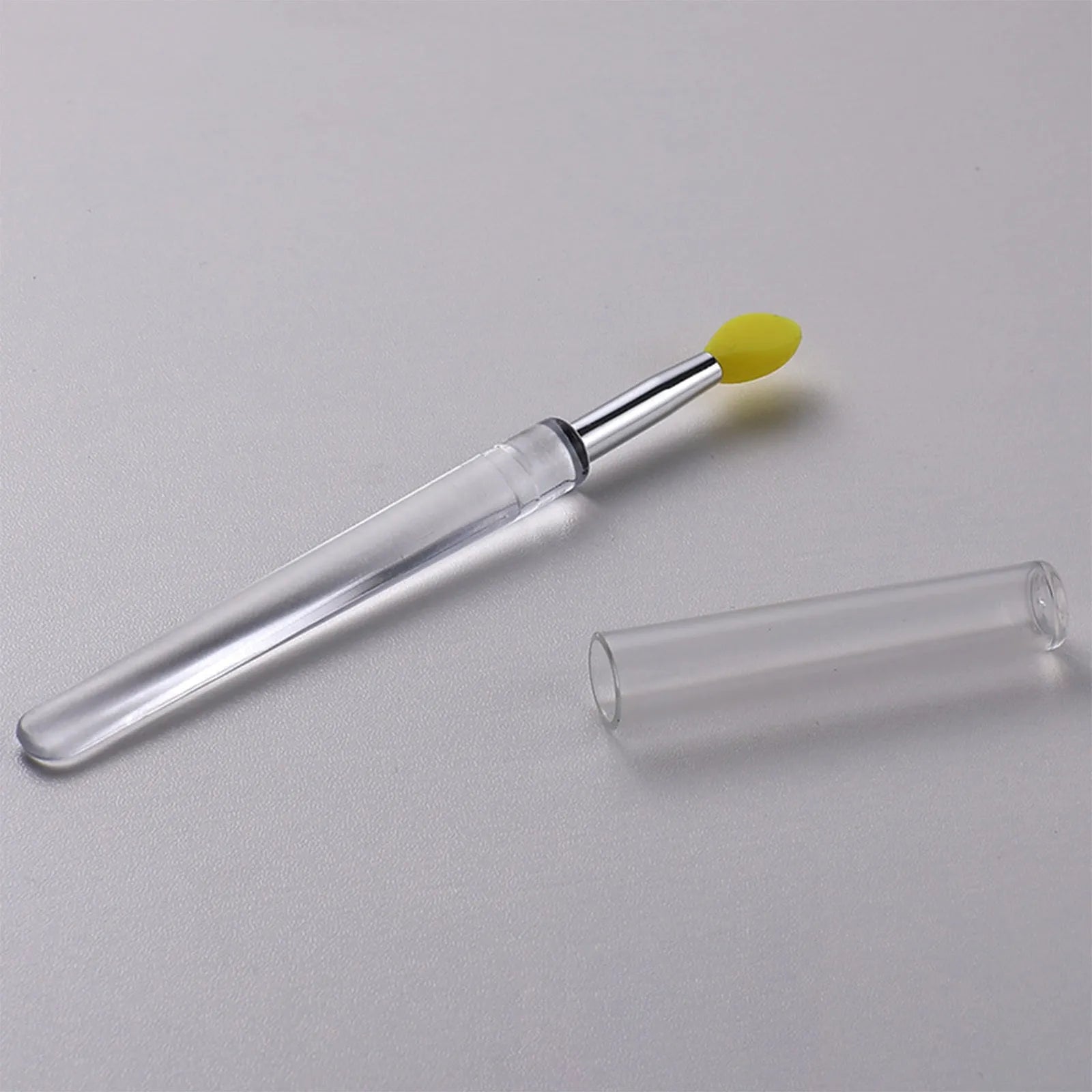 Silicone lip brush with protective cap for hygienic lip product application