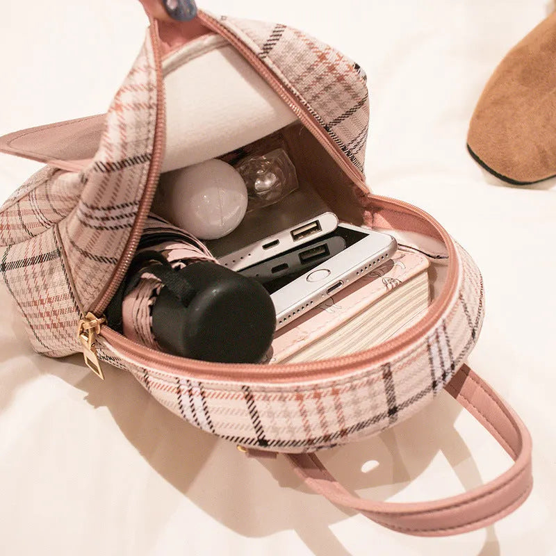 Diagonal shoulder phone bag in PU material showing adjustable strap and handheld carry option