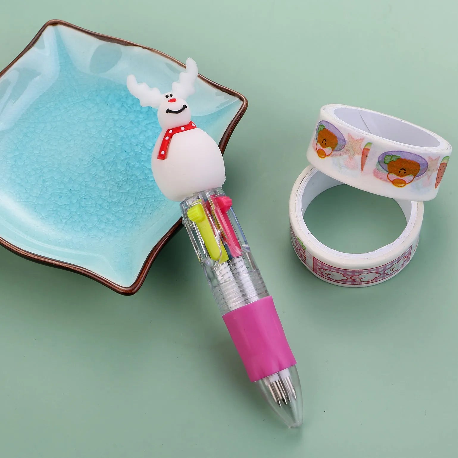 Compact 11cm Christmas four-colour press pen with festive designs including reindeer and snowmen.