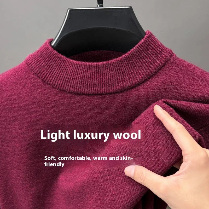 Man wearing a solid colour half turtleneck long sleeve jumper in a casual setting.