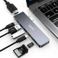 Silver aluminium USB-C 7-in-1 adapter hub with SD card slot, Micro SD slot, HDMI, USB 3.0, and USB-C ports