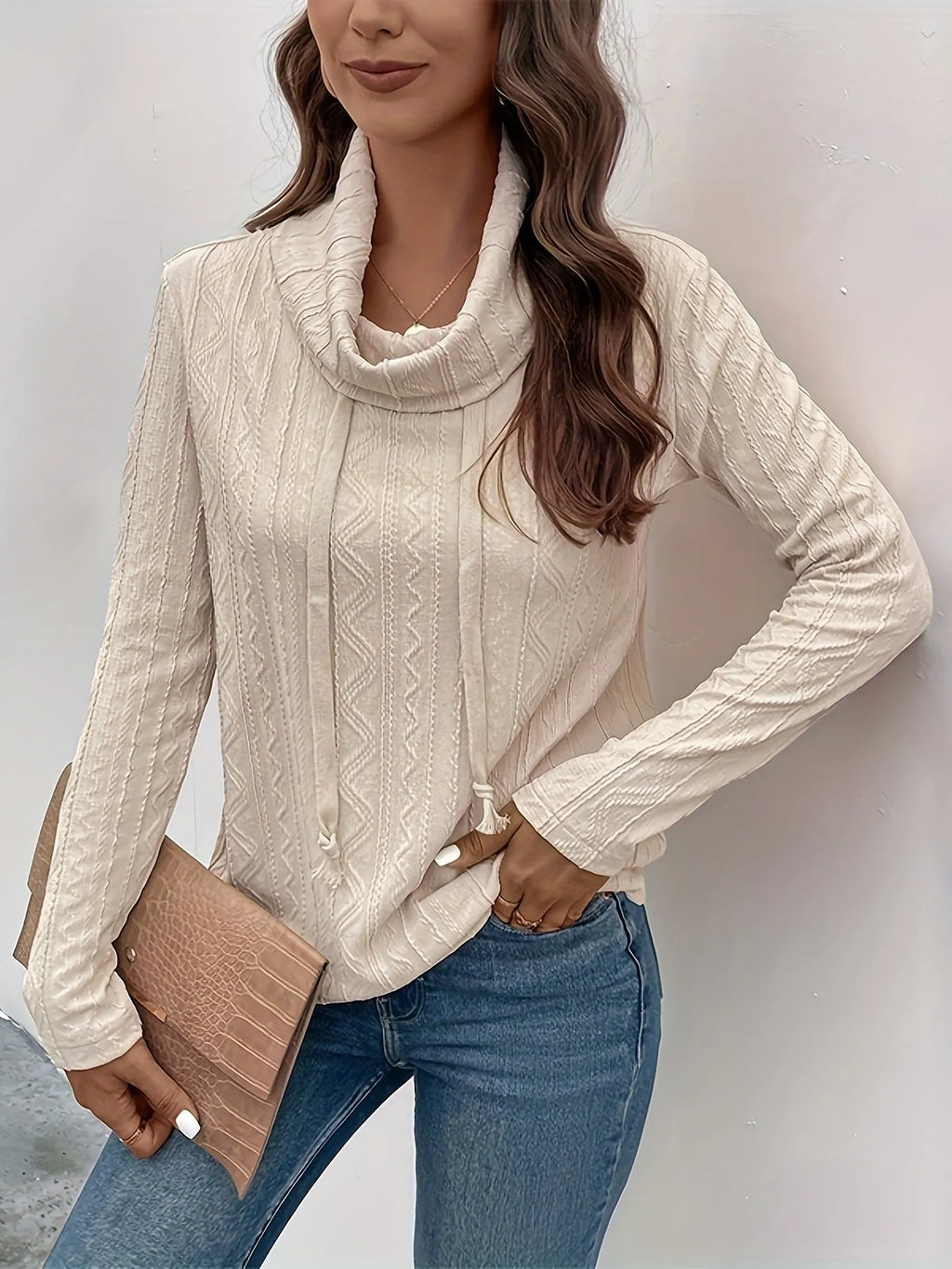 Apricot coloured hooded pullover sweater with drawstring and long sleeves laid flat