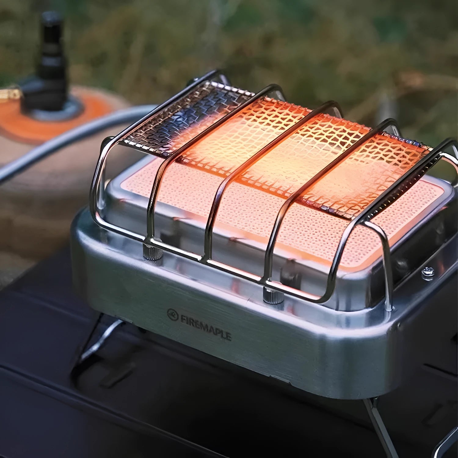 Portable outdoor heating stove with metal finish shown expanded to 180x167x125mm and collapsed for storage