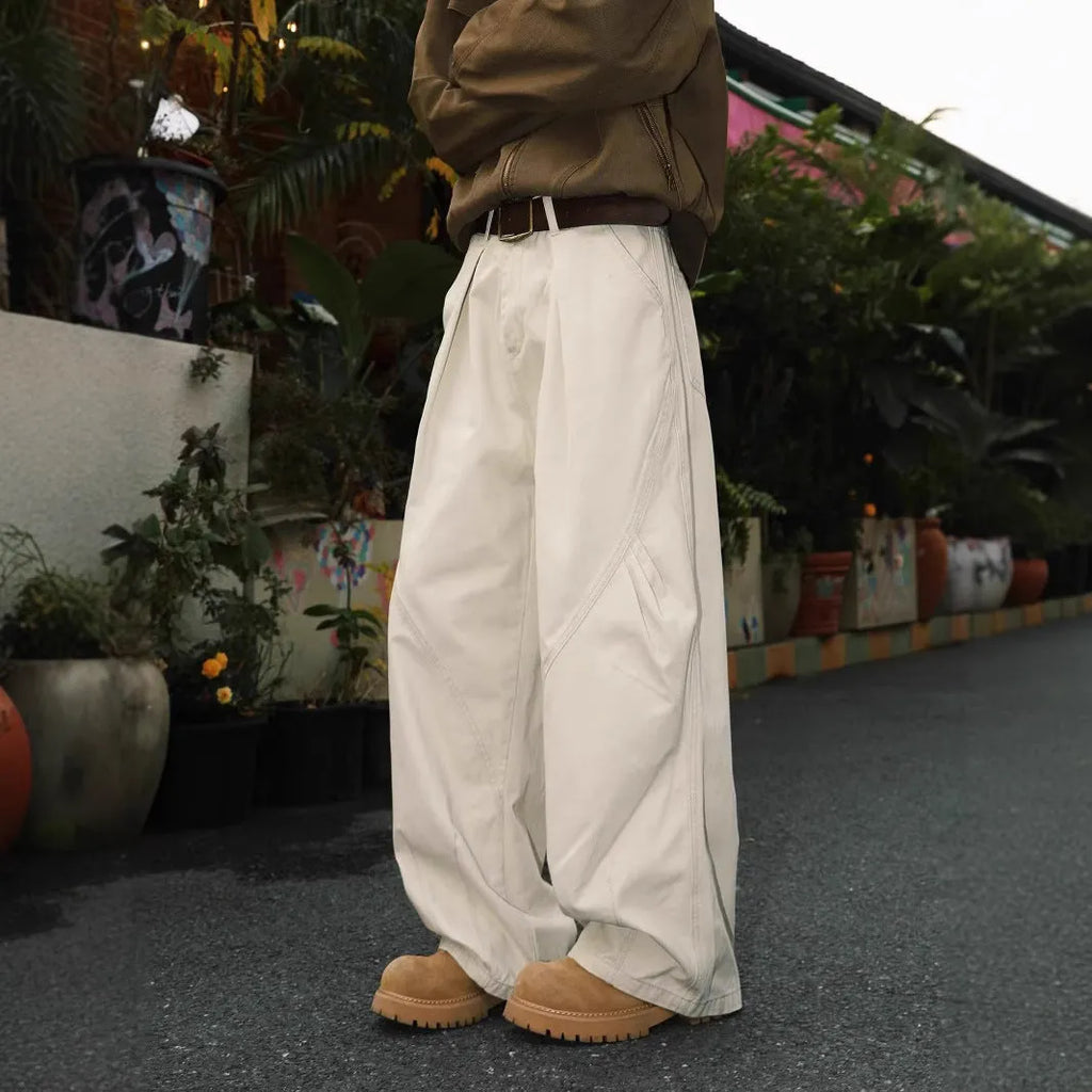 Men's pleated straight-leg trousers in apricot colour showing elasticated waistband detail.