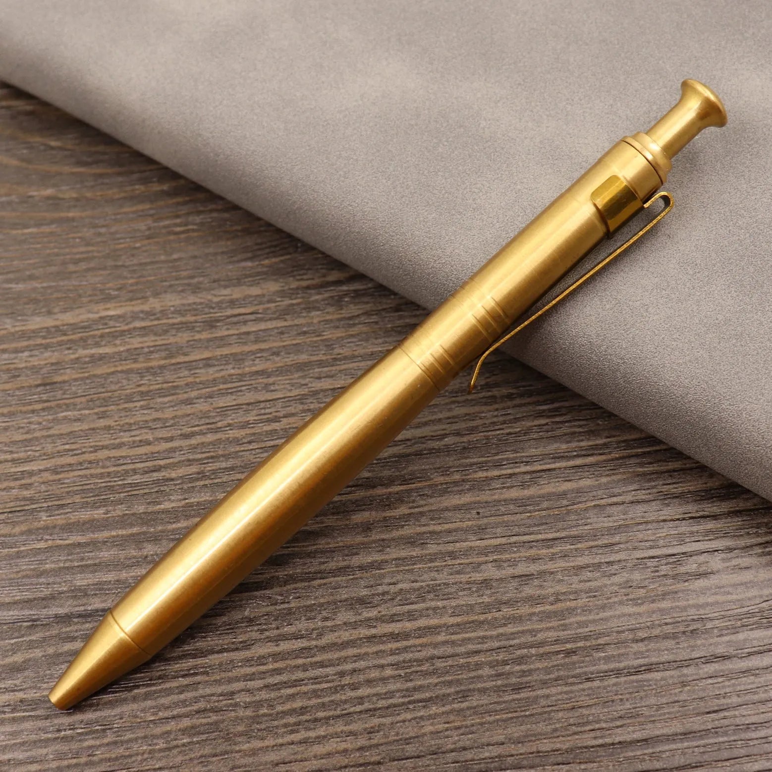 Retro brass tactical pen with bolt action mechanism in brushed natural finish