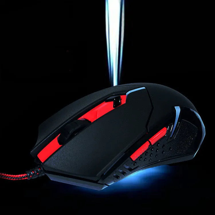 Black and red ergonomic USB wired gaming mouse with six buttons on a desk.