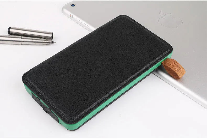 Black solar power bank with a solar panel, LED light, USB ports, and a soft leather casing.