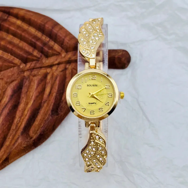 Stainless steel women's watch with round dial on wrist, showing gold surface finish option.