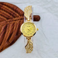 Stainless steel women's watch with round dial on wrist, showing gold surface finish option.