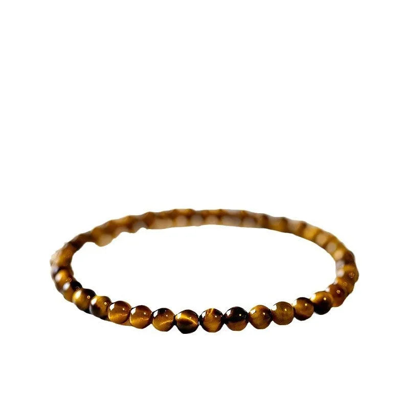 Natural tigereye gemstone bead bracelet in New Chinese geometric style on a wrist.