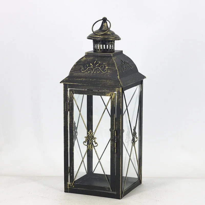 Black and white wrought iron floor-standing storm lantern with tempered glass panels for courtyard use