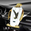 Black and gold wireless charging car phone holder with eagle design and suction cup.