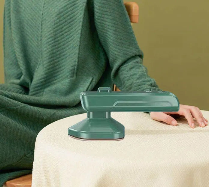 Dark green portable hanging steam iron machine with ceramic panel and compact design.