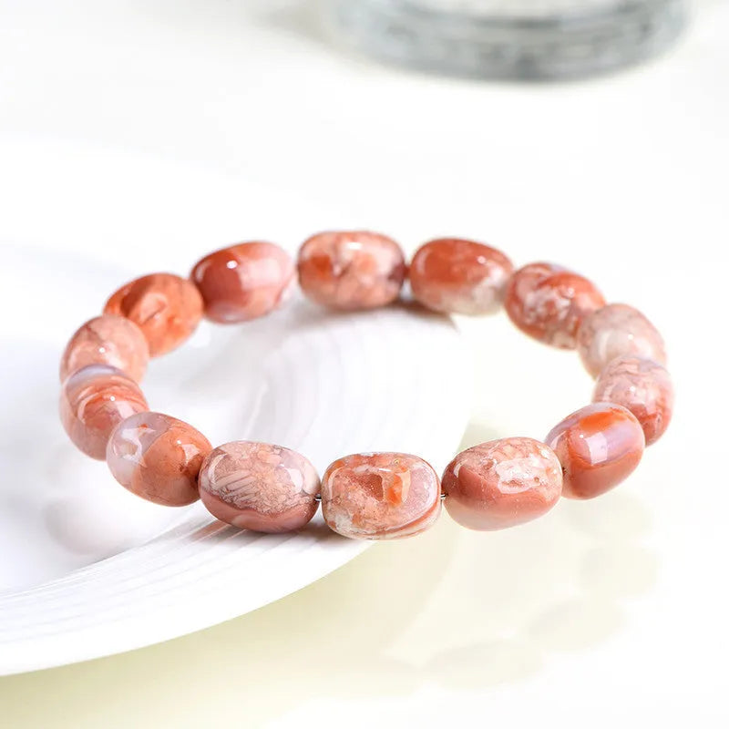 Natural cherry agate bracelet with barrel-shaped beads showing Ruyi geometric design
