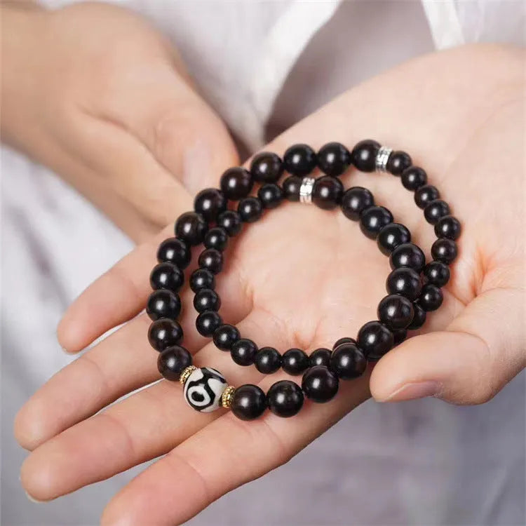 Ebony wood Tibetan bracelet with 8mm beads and two-circle pattern on wrist
