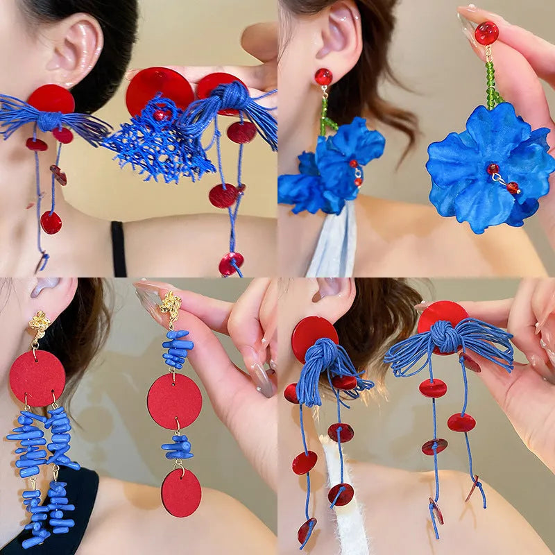 Geometric cloth hoop earrings with blue resin flower detail and manual processing
