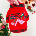 Green Christmas pet sweater for a small dog on a festive background.