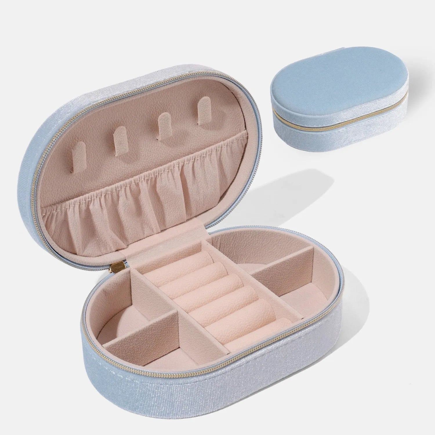 Oval velvet jewellery storage box in lake blue colour showing flannel interior and compact 15x10x5cm dimensions
