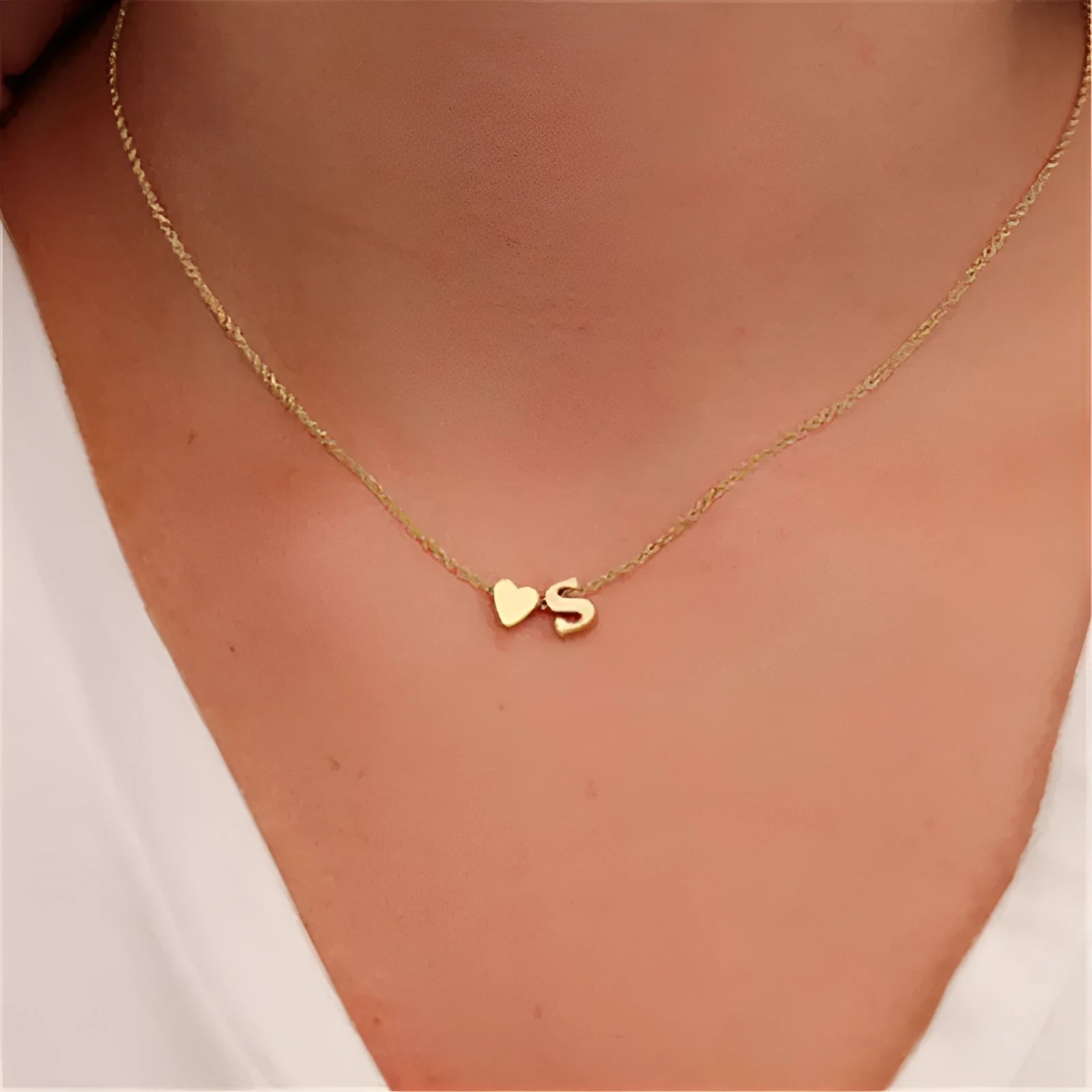 Peach heart shaped alloy pendant necklace charm in a gold colour finish on a model.
