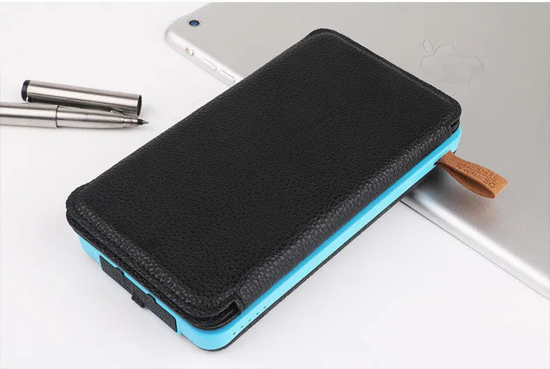 Black solar power bank with a solar panel, LED light, USB ports, and a soft leather casing.