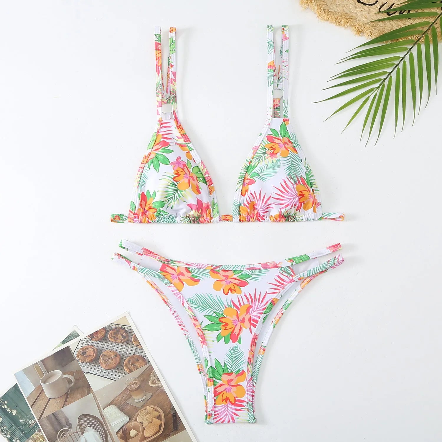 Women's printed floral halterneck two-piece swimming briefs set in blue on a mannequin.