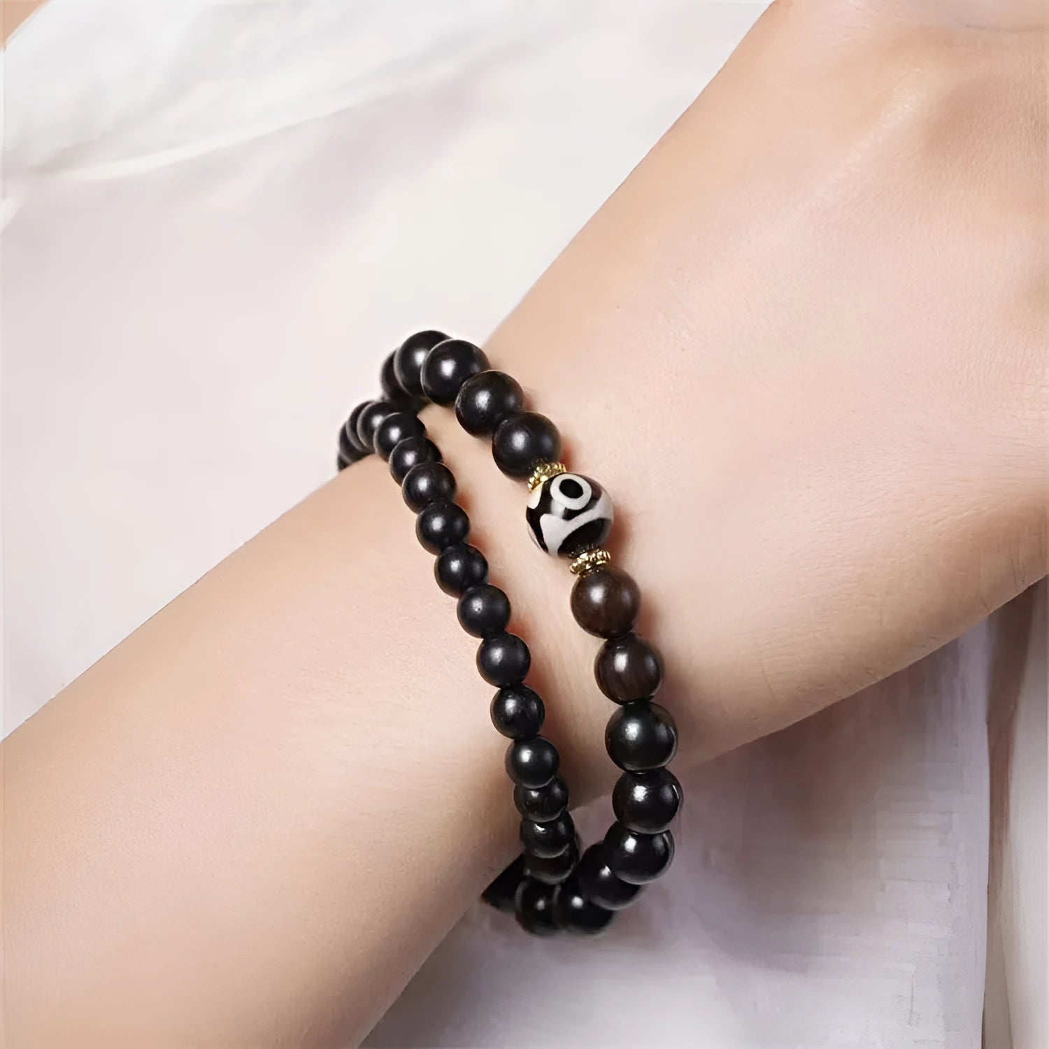 Ebony wood Tibetan bracelet with 8mm beads and two-circle pattern on wrist